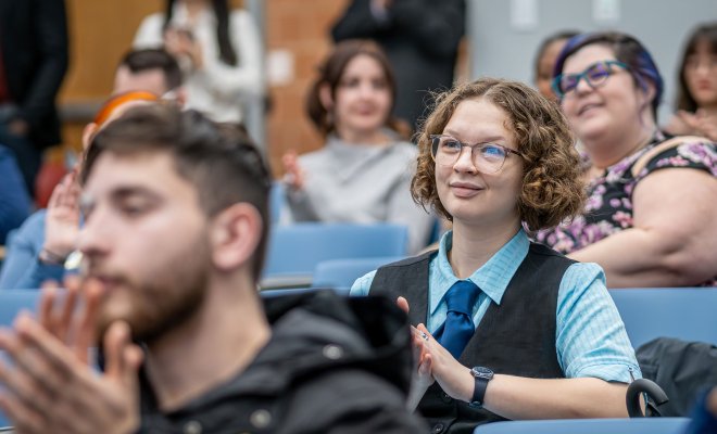 International language learners in lecture hall.