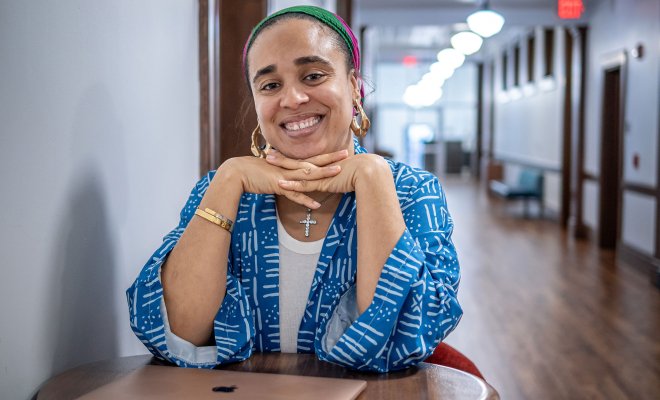 Cookie Howard sits at a table in a hallway in Susan A. Cole Hall.