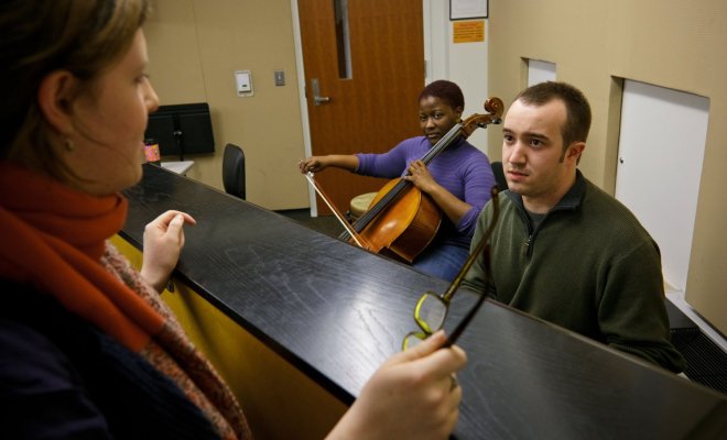 Instructor speaking to students over a wall.