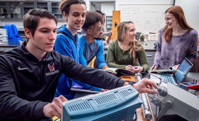 Students in a lab taking readings off an oscilloscope.
