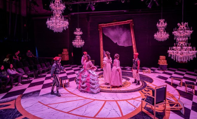 Actors on stage in a production of Marie Antoinette.
