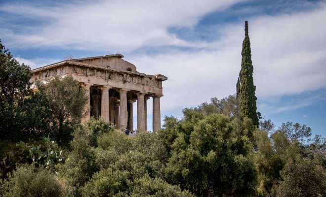 Photo of the Parthenon framed by trees taken during Study Abroad in Greece.