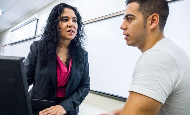 Instructor in conversation with a student.