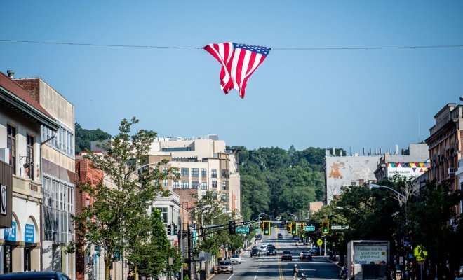photo of Bloomfield Ave in Montclair with American flag waving overhead.