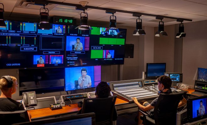 Three high school students watch television monitors, gaining hands-on experience at Montclair’s state-of-the-art School of Communication and Media.