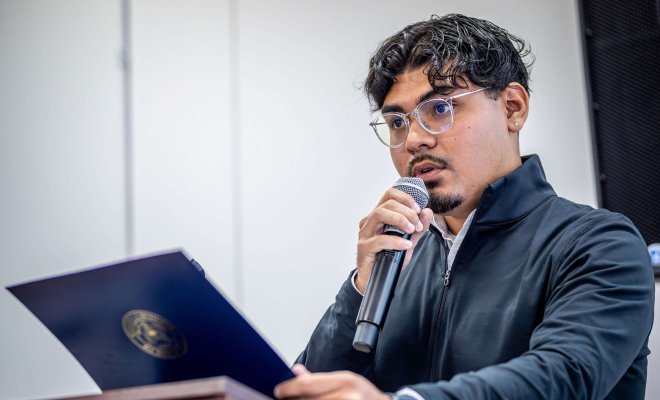Student speaking at podium.