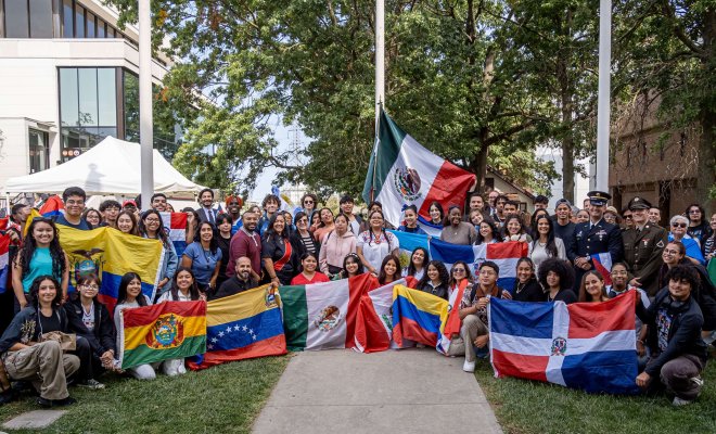 Students pose with flags of different Latin American nations.