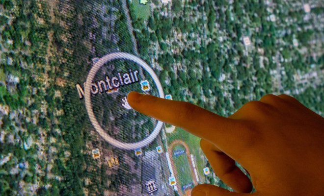A close-up image of a finger pointing to Montclair on a map.