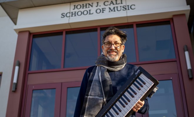 Bob Bailey-Lemanskyholds a keyboard outside the Cali School of Music.