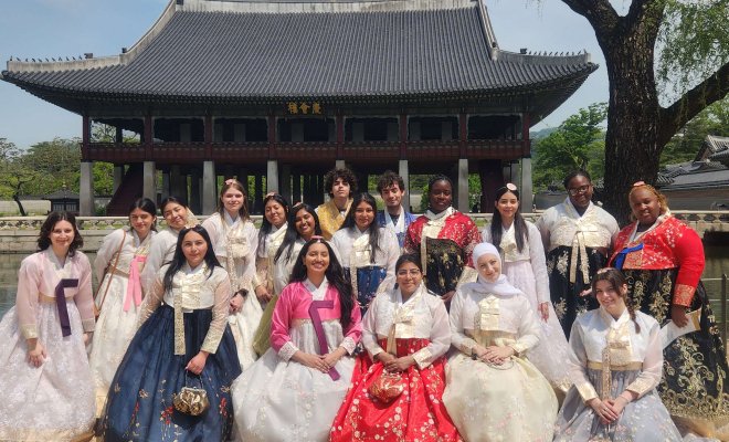 Students wearing hanboks facing the camera.