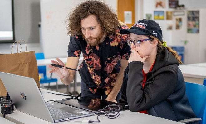 A college professor helps a student with a class project at Montclair State University.