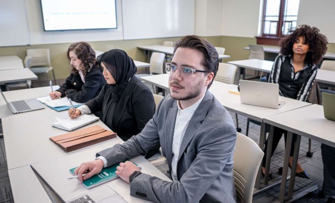 Students taking notes in class.