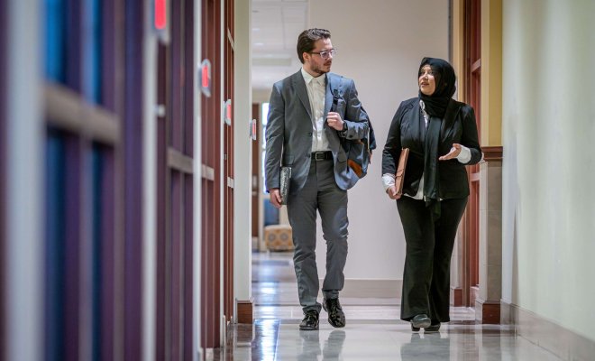 Two educational administrators walk together at Montclair State University.