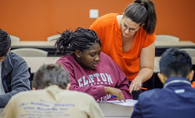 A college professor helps a student at Montclair State University.