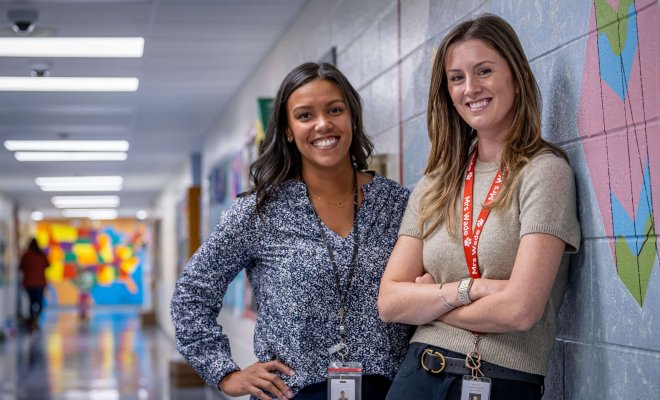 Two educational administrators pose together in a school.