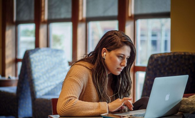student focused on laptop.