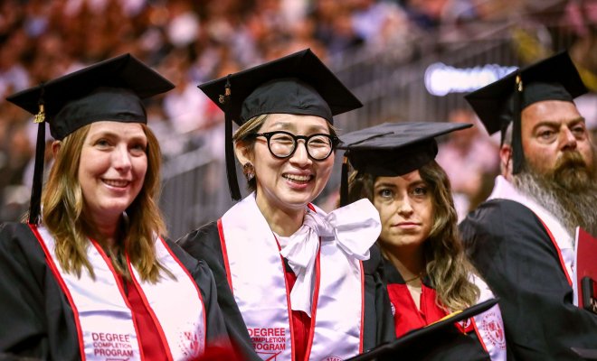 A group of Montclair State University graduates is seated at a commencement ceremony