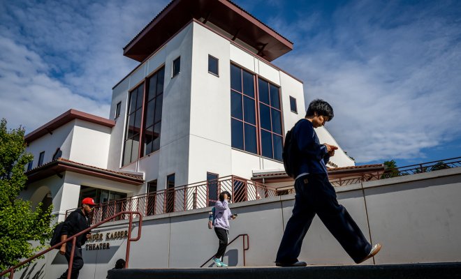 Students climbing stairs or walking in front of the Kasser Theater.