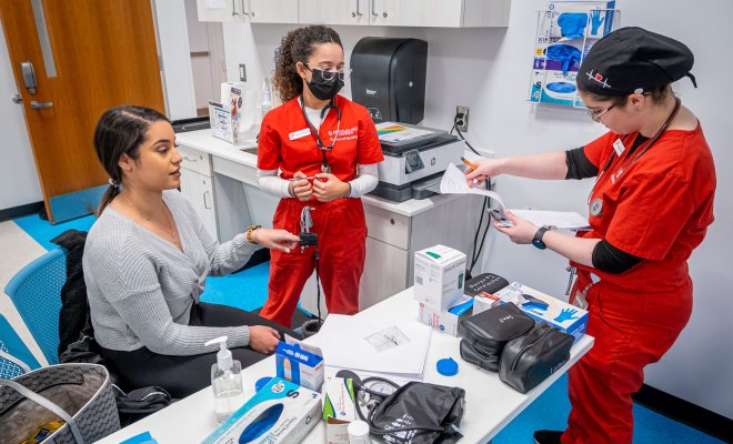 Three nursing students are collaborating together.