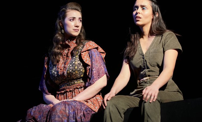 Two female students on stage performing.