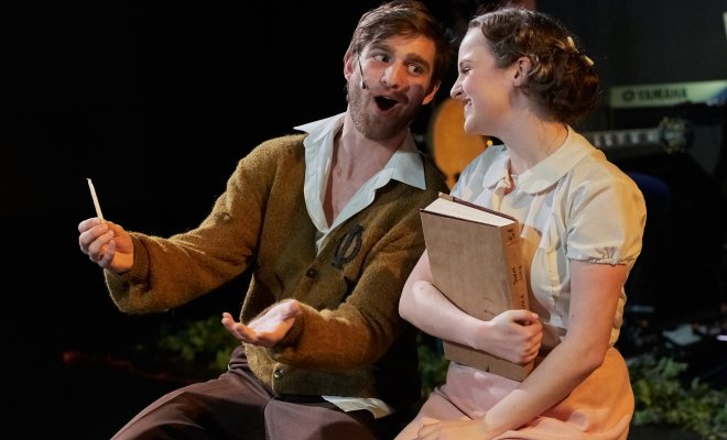 Two students are on stage enacting a play.
