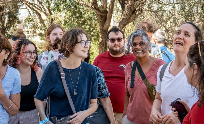 Group of men and women speaking while studying abroad.