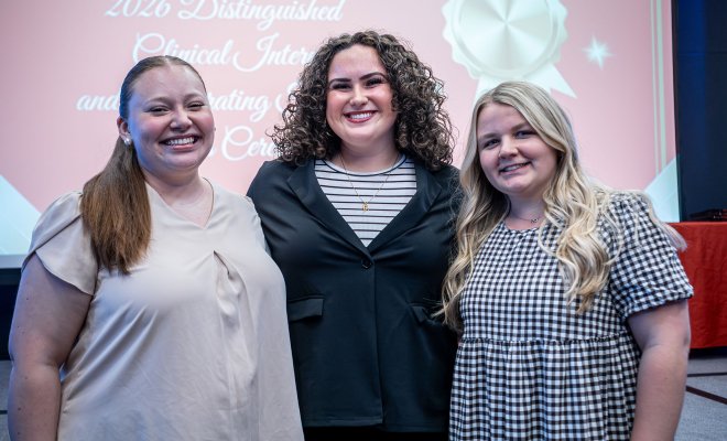 Lydia Brubaker, Juliana Di Cosmo and Maddie Heinold all posing in front of a projector.