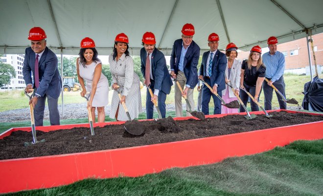 President Jonathan Koppell and University leadership pose with shovels at the building groundbreaking