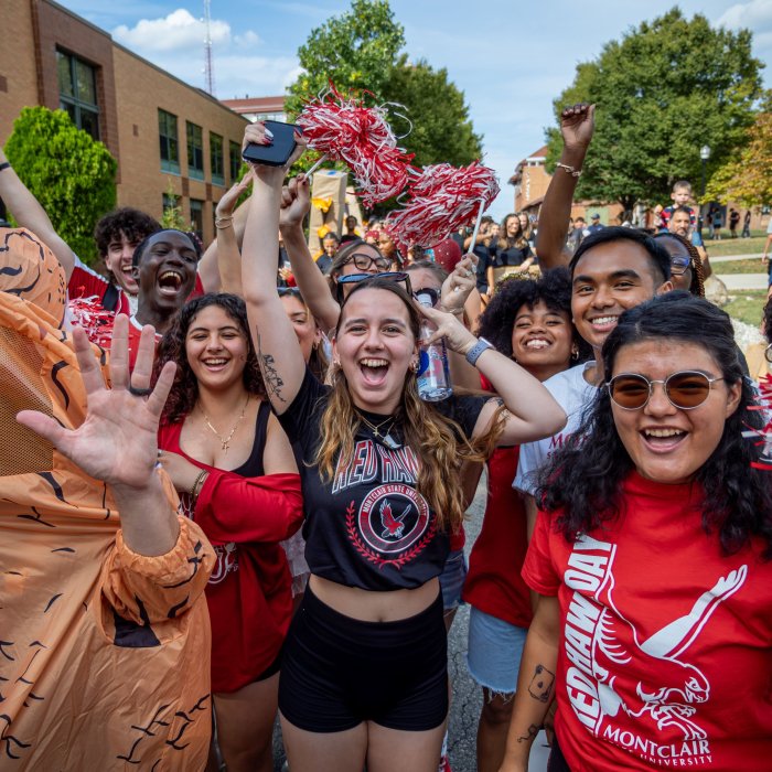 A crows of students at homecoming shouting for the camera