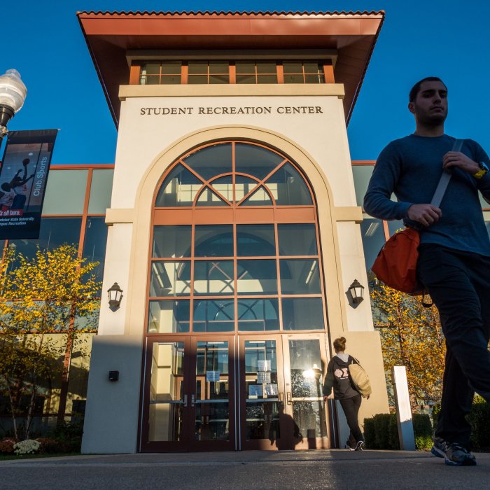 Students walk in front of the Student Recreation Center. 