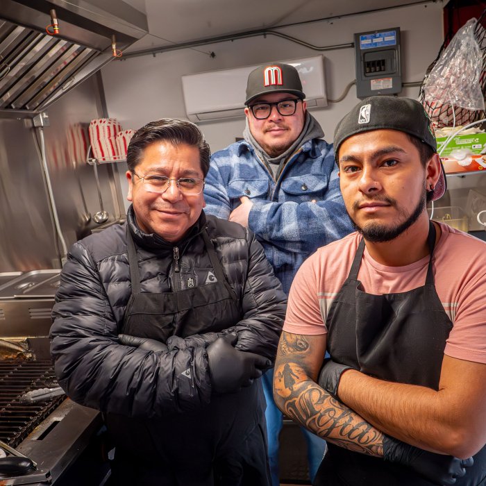 Three men inside the Señor Tacos food truck