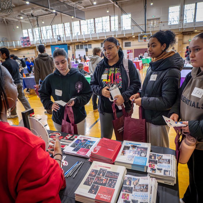 Four students listen to information about majors.
