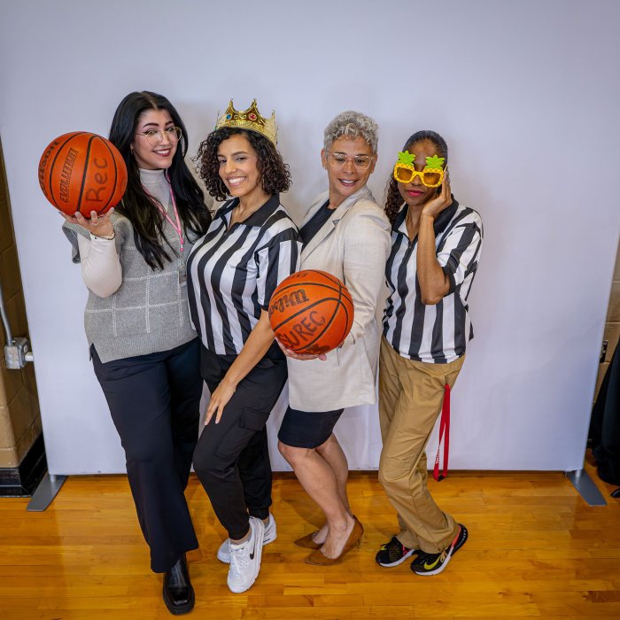 Advisors pose with basketballs at Major Madness.