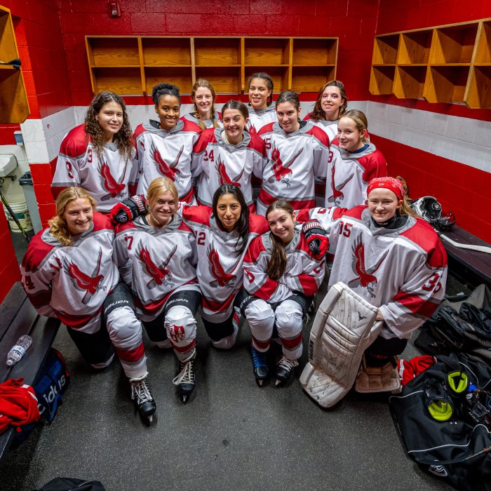 group photo of Montclair State University Women's Ice Hockey Team in locker room