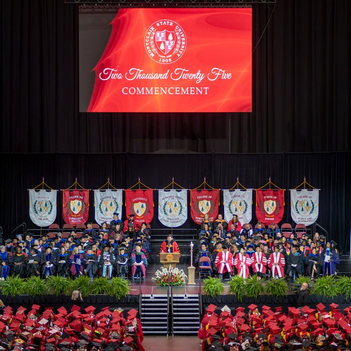 Deans, faculty and staff seated on stage at Prudential Center