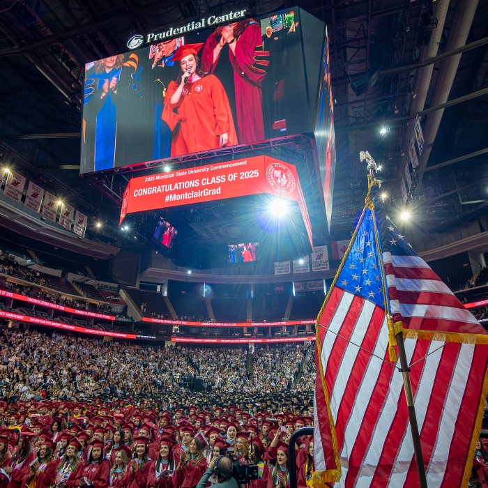 photo of Prudential Center jumbotron showing graduate Sydney Emile Swearengin singing the national anthem