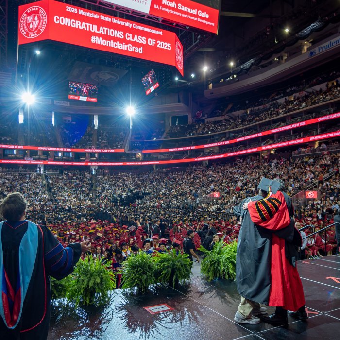 President Koppell embraces a graduate on stage