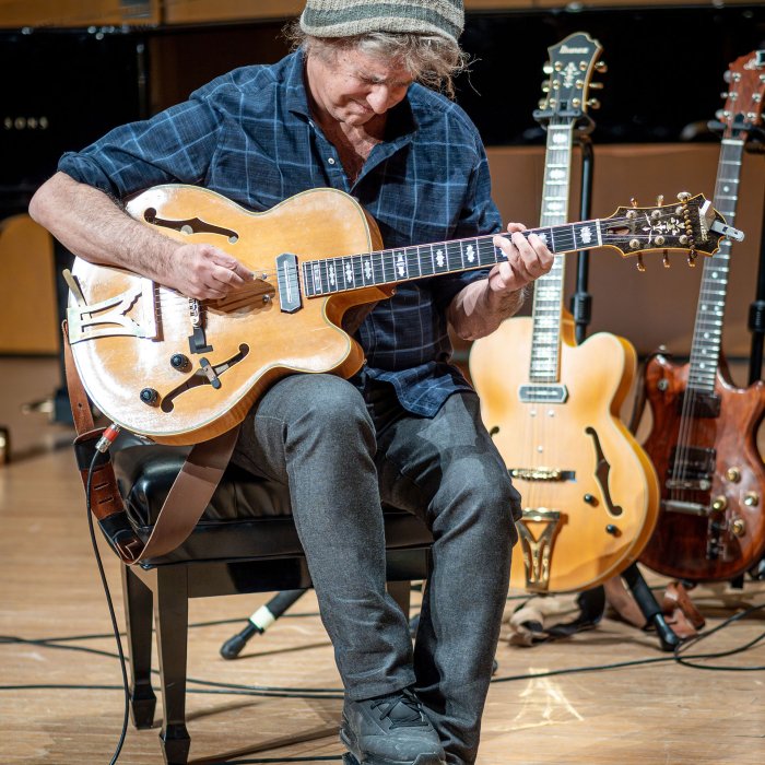 Pat Metheny plays guitar on stage