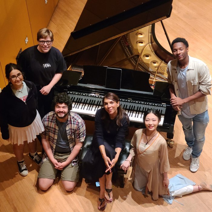 overhead photo of students around a piano with Lara Downes