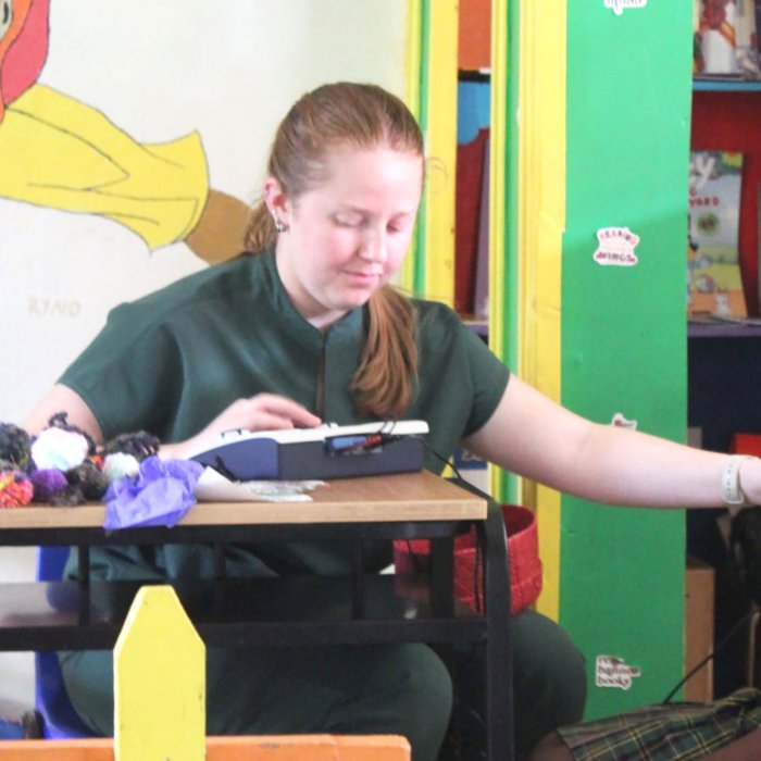 Audiology student Mary McCourt works tests a student’s hearing in Dominica.