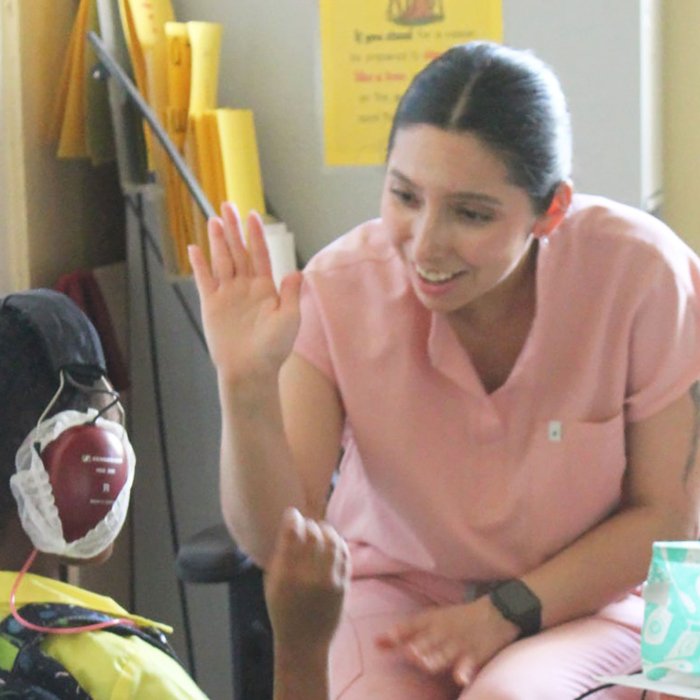 Audiology student Angelica Ramos-Lopez works with a student while visiting Dominica on a humanitarian mission trip.