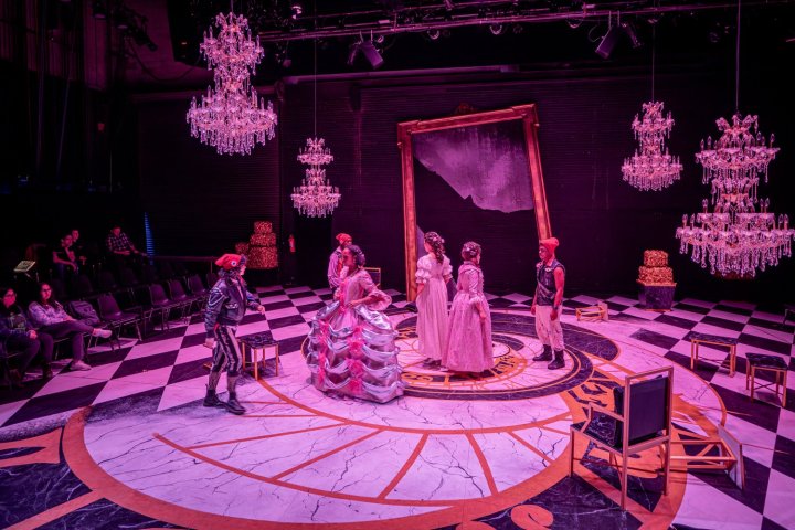 Actors on stage in a production of Marie Antoinette.