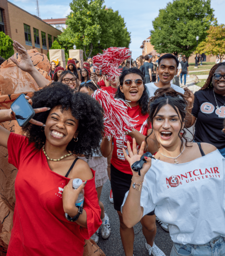 Group of student smiling and posing at Homecoming.