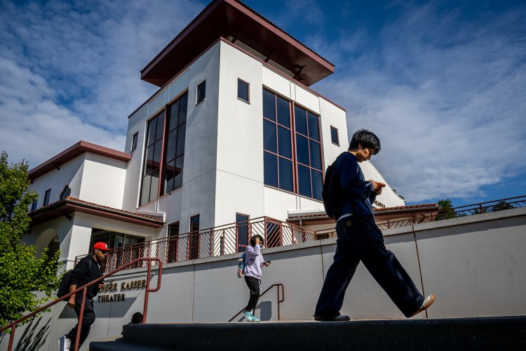Students climbing stairs or walking in front of the Kasser Theater.
