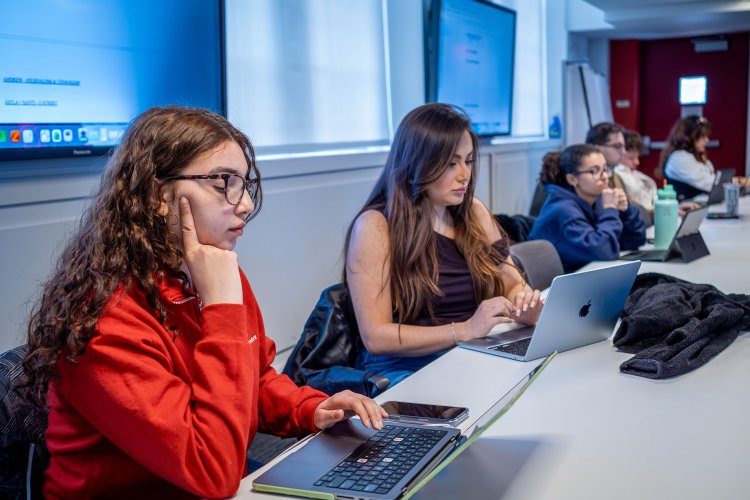 Students working on their laptops during class.