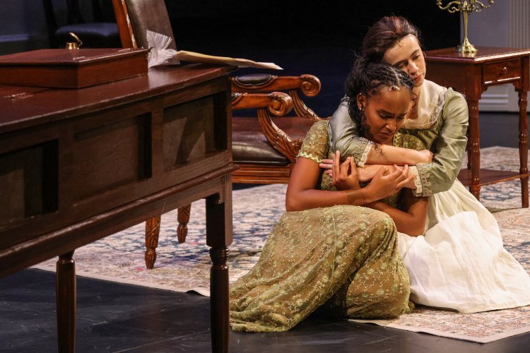 Two performers on stage enacting the pride and prejudice play.