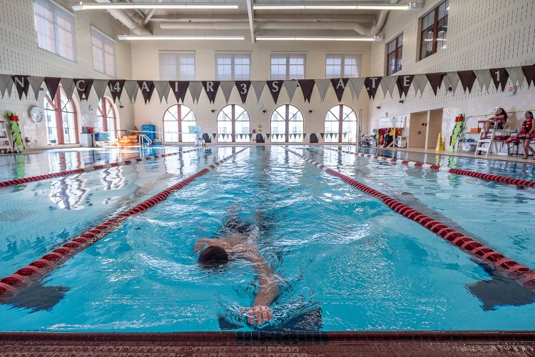 A student swimming in the rec center.