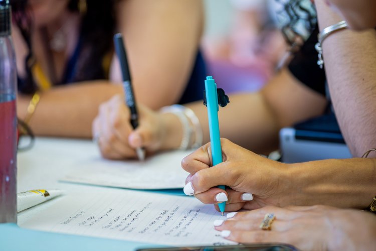Students writing notes.