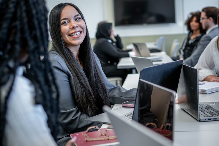 Student Sitting in Classroom Smiling