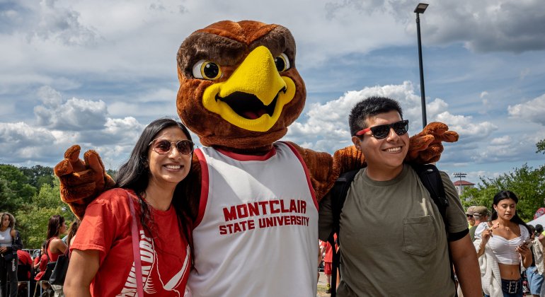 Rocky taking a photo with two students.